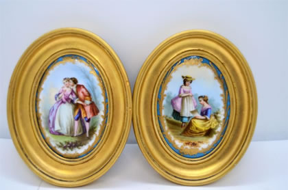 Pair of gilt framed painted porcelain panels