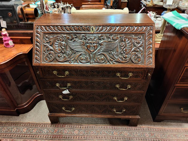 19th century carved oak bureau with gilt metal handles