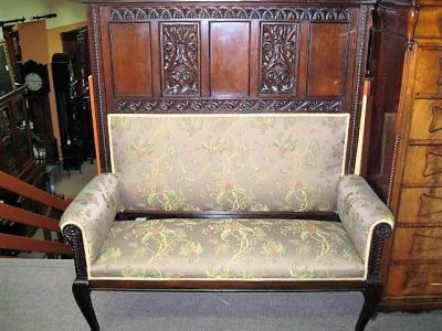 An 18th century carved oak bench 
