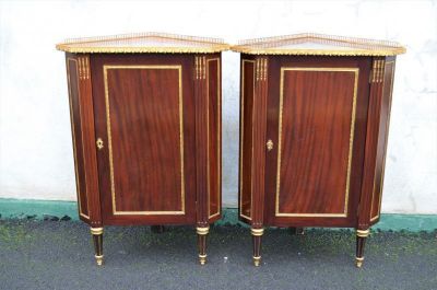 Pair of french mahogany corner cabinets with brass gallery