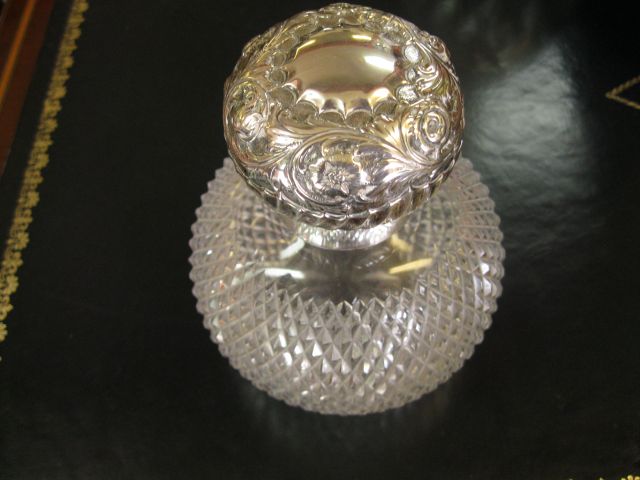 A silver topped perfume bottle
