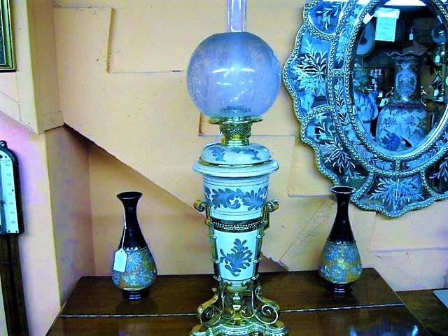 A victorian brass and pottery lamp 